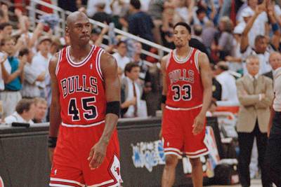 Chicago Bulls guard Michael Jordan and forward Scottie Pippen (33) walk back to the bench during a timeout in the closing seconds of an NBA basketball playoff game in 1995. AP