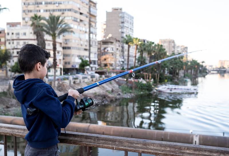 A boy fishing on the Manasterly Bridge over the Nile in Cairo
