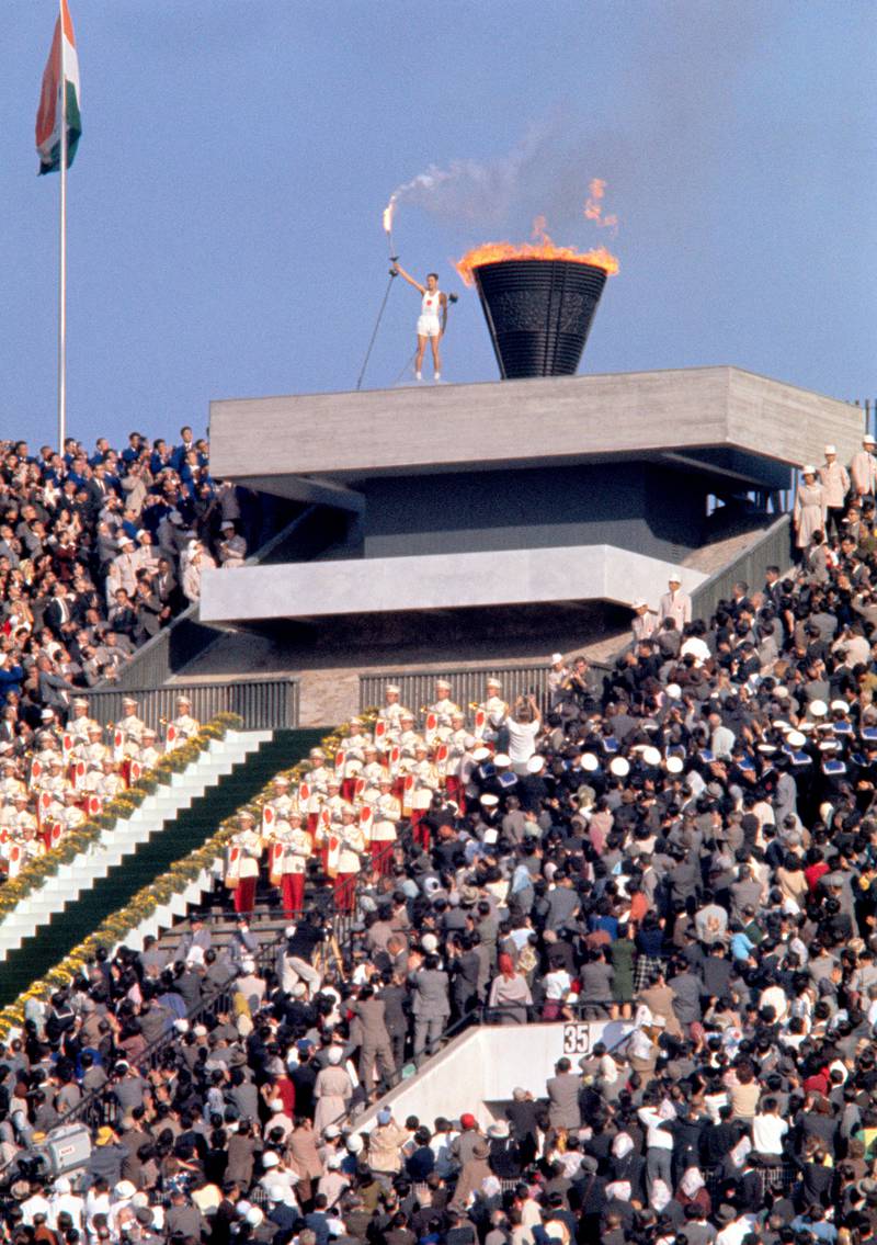 10 Oct 1964, Tokyo, Japan --- Original caption: Yoshinori Sakai touches Olympic torch to the urn signifying start of the 18th Olympiad. --- Image by Â© Bettmann/CORBIS *** Local Caption ***  bz23se-p6-Japan-MAIN.jpg