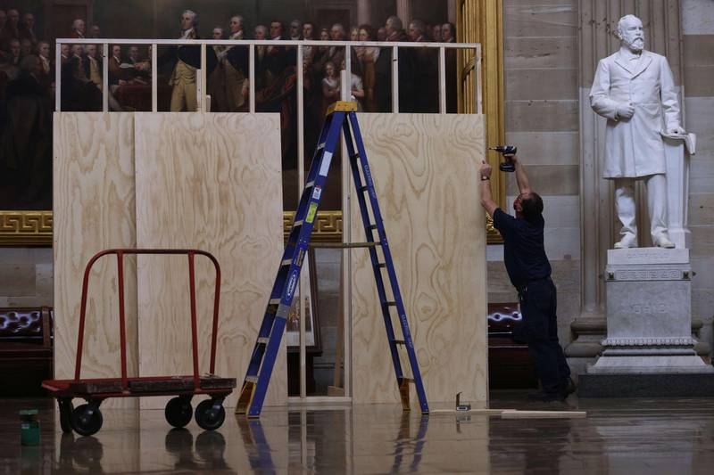 A worker builds a wooden structure, part of the preparation for the presidential inauguration, at the Rotunda of the US Capitol. AFP