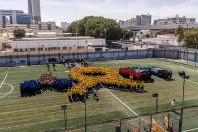 Pupils from St Mary’s Catholic School in Dubai line up in formation as part of an effort to raise funds to cover treatment of low-income cancer patients. All photos: Antonie Robertson / The National