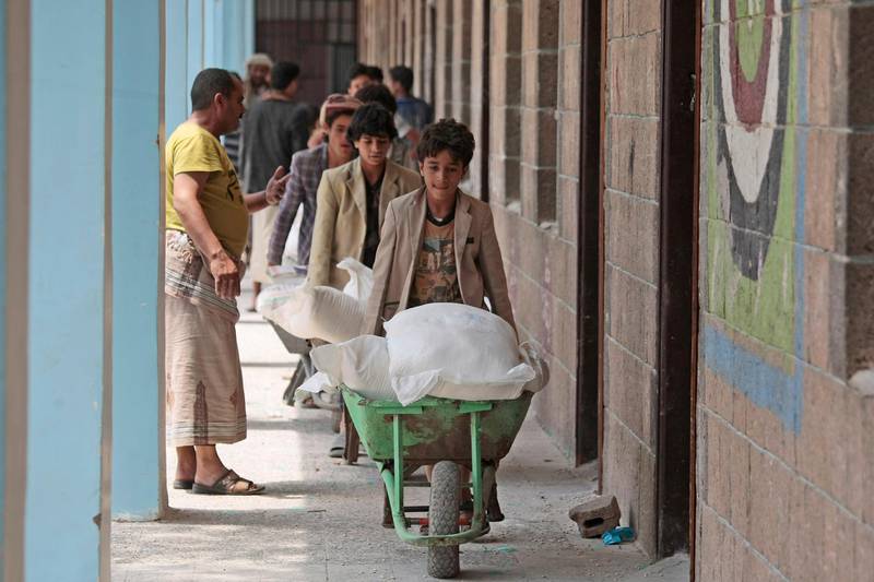 Displaced Yemenis receive food supplies provided by the World Food Programme, at a school in Sanaa, Yemen. AP Photo