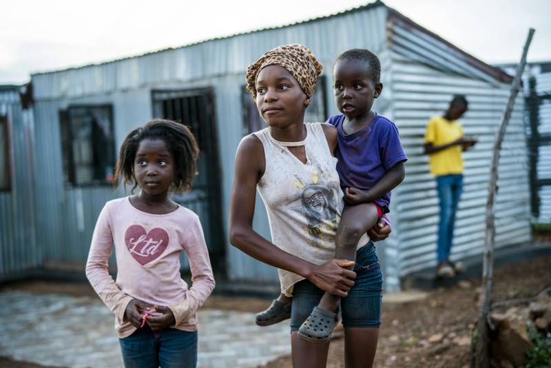 Children walk through the settlement of Vlakfontein outside Johannesburg in South Africa.  Although children under 12 are not taking part in the country's Covid-19 vaccination campaign, cases in young children are on the rise since the discovery of the Omicron variant.  AP