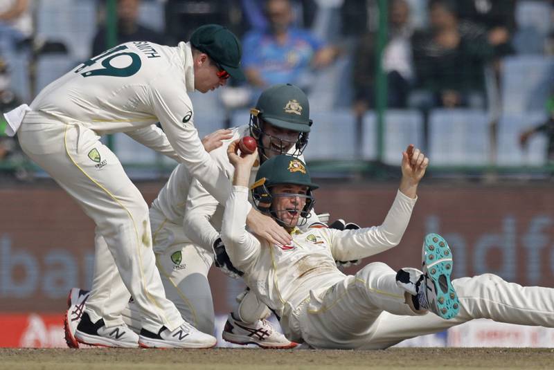 Australia's Peter Handscomb celebrates with teammates after taking a catch to dismiss India's Shreyas Iyer. Reuters