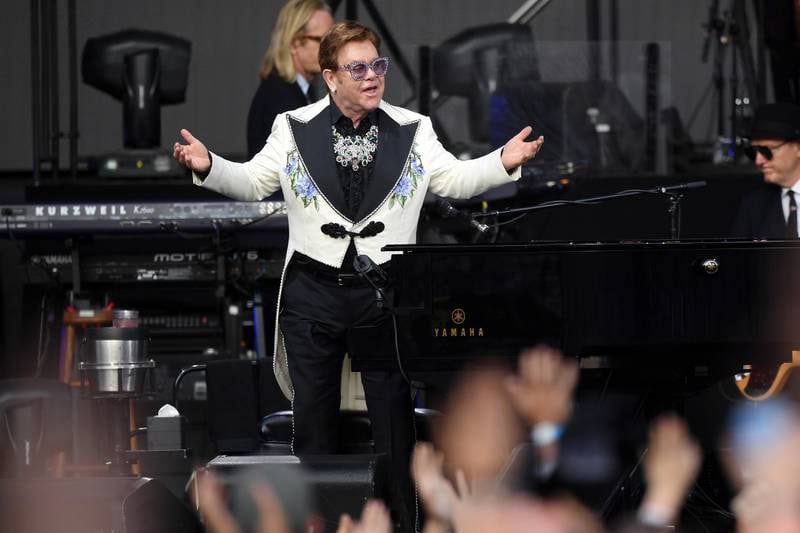 Elton John, in a black and white suit with floral detail, performs at Mission Estate, New Zealand on February 6, 2020. Getty Images
