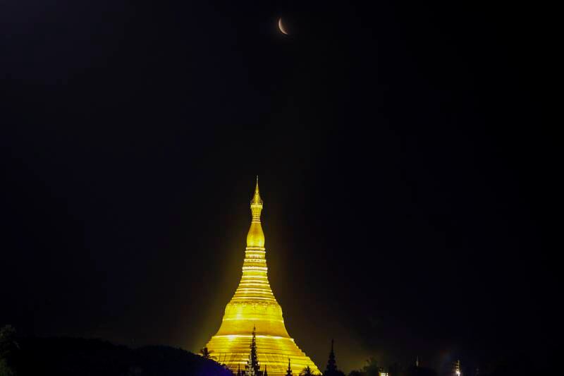 The moon rises above Myanmar's landmark Shwedagon pagoda during the eclipse, in Yangon. AP