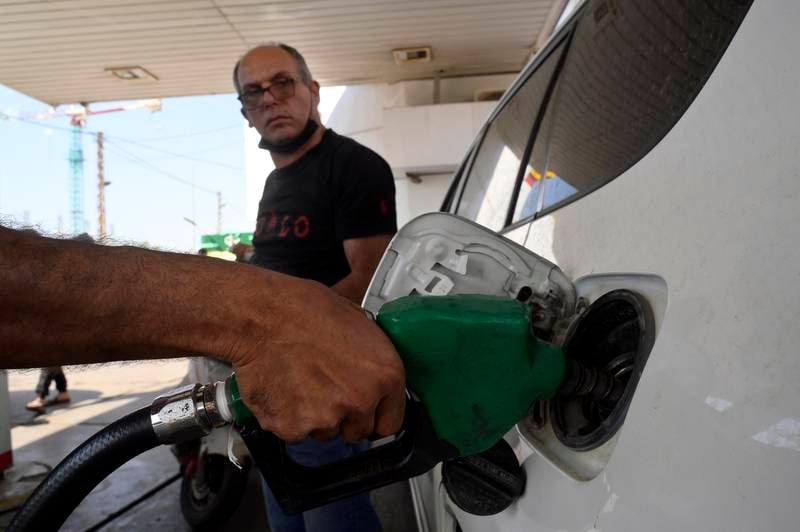 A motorist gets petrol in the town of Damour in south Beirut. EPA