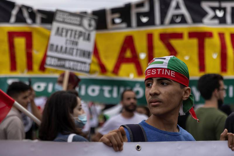 A pro-Palestinian protester holds a banner during a demonstration outside the Israeli embassy in Athens, Greece. Reuters