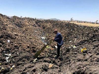 In this photo taken from the Ethiopian Airlines Facebook page, the CEO of Ethiopian Airlines, Tewolde Gebremariam, looks at the wreckage of the plane. AP Photo