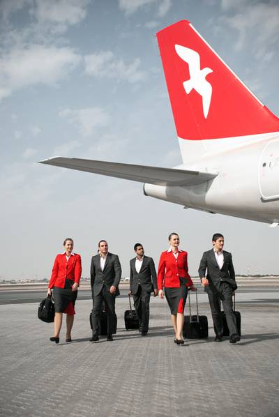 Air Arabia crew members in the airline's previous uniforms.