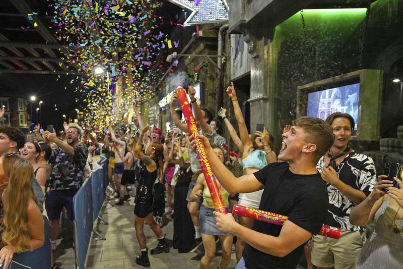 People celebrate as they queue to enter a nightclub in Leeds after the final legal coronavirus restrictions were lifted in England at midnight.