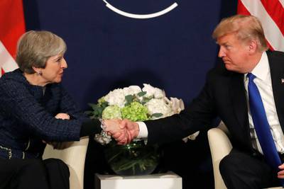 U.S. President Donald Trump shake hands with Britain's Prime Minister Theresa May during the World Economic Forum (WEF) annual meeting in Davos, Switzerland January 25, 2018 REUTERS/Carlos Barria     TPX IMAGES OF THE DAY