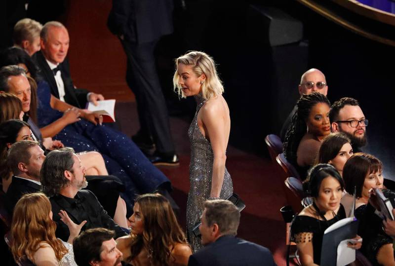 Brie Larson chats to Amy Adams as Michael Keaton looks on. Photo: Reuters