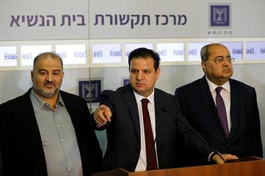 Members of the Joint List Ayman Odeh, center, speaks to the press in the presence of Ahmad Tibi, right, and Mansour Abbas following their consulting meeting with Israeli President Reuven Rivlin. AP