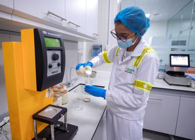Abu Dhabi, United Arab Emirates, February 2, 2021.  A look inside Pinar, the UAE’s first processed cheese factory in Abu Dhabi. --  Crystal D'Costa, Microbiologist, conducts some tests in the Pinar lab.Victor Besa/The National.Section:  NAReporter :  Nilanjana Gupta