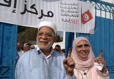 Ennahdha's presidential candidate Abdelfattah Mourou and his wife show their ink-stained fingers after casting their votes during presidential election at a polling station in La Marsa on the outskirts of the capital Tunis. Rarely has the outcome of an election been so uncertain in Tunisia, the cradle and partial success story of the Arab Spring, as some seven million voters head to the polls today to choose from a crowded field.  AFP