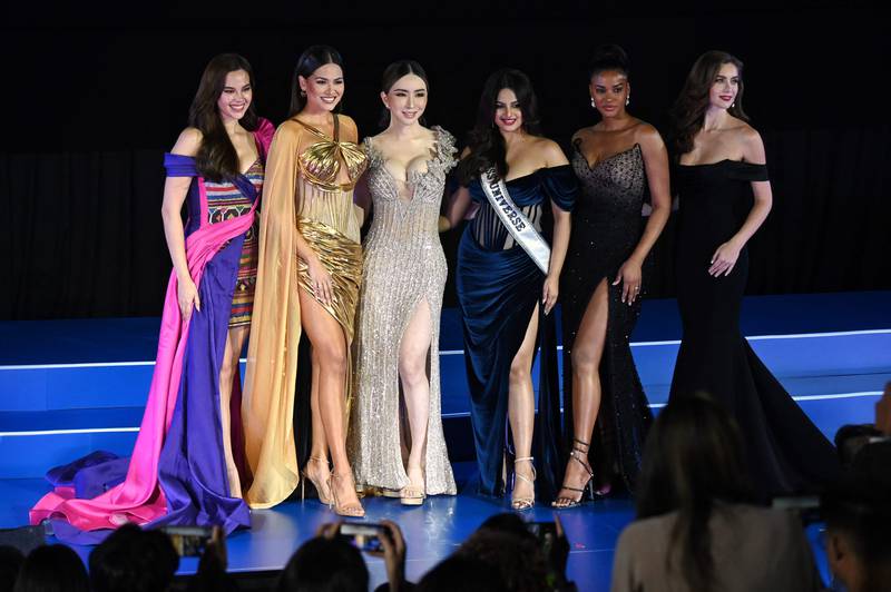 Miss Universe winners through the years and the organisation's new owner Anne Jakkaphong Jakrajutatip at the Miss Universe Extravaganza in Bangkok, Thailand. From left, Catriona Gray (Philippines), Andrea Meza (Mexico), Jakrajutatip, Harnaaz Sandhu (India), Leila Lopes (Angola) and Natalie Glebova (Canada). All photos: AFP
