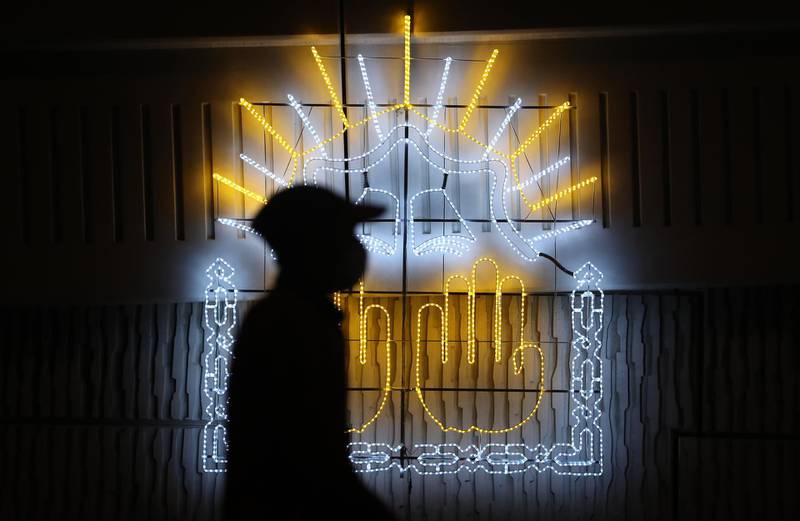 AJMAN, UNITED ARAB EMIRATES , April 23– 2020 :- Ramadan decoration at one of the bridge on Sheikh Maktoum Bin Rashid street in Ajman. One of the person crossing the street and wearing the protective face mask.  (Pawan Singh / The National) For News/Standalone/Online/Instagram