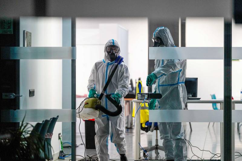 Military Emergencies Unit members carry out disinfection procedures at a temporary coronavirus disease Covid-19 testing site in Madrid, Spain. Bloomberg