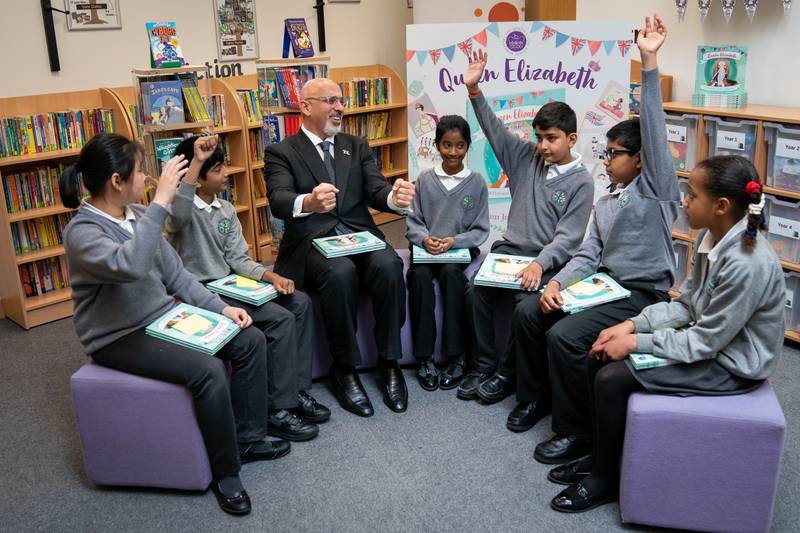He answers questions from 5 pupils after reading a commemorative jubilee book during a visit to Manor Park Primary School in Sutton, when he was education secretary, in May 2022. PA