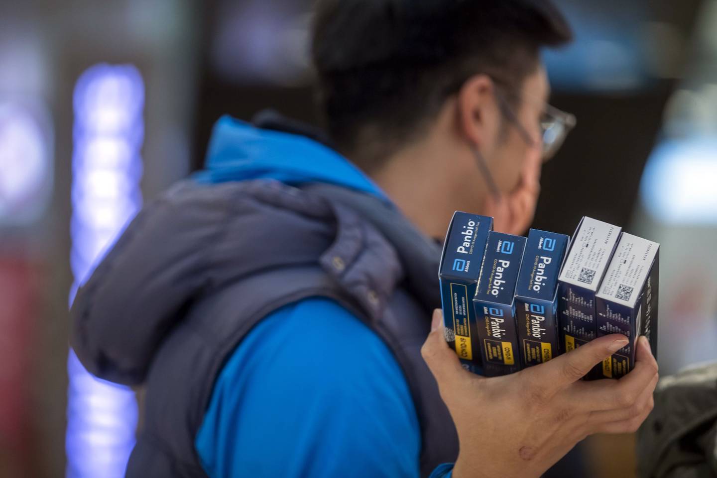 A customer holds Abbott Laboratories Panbio Covid-19 rapid antigen test kits at a store in Hong Kong. The IMF suggested that each country should have equal access to a Covid-19 toolkit. Bloomberg 