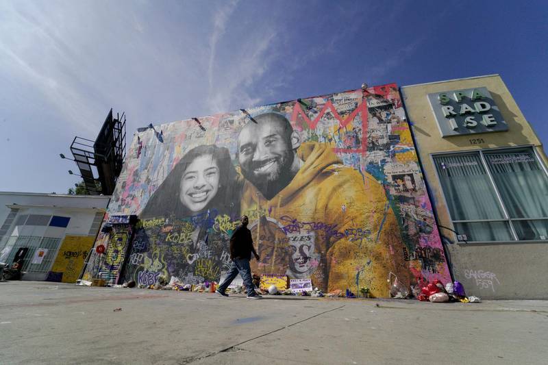 Fans gather around a mural of late NBA great Kobe Bryant and his daughter Gianna Bryant during a public memorial for them and seven others killed in a helicopter crash, at the Staples Center in Los Angeles, California, US, February 24, 2020. REUTERS