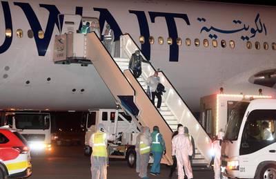 Kuwaitis returning from Frankfurt leave an aircraft that landed at the Kuwait International Airport. AFP