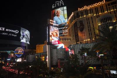 Images of Queen Elizabeth on casino marquees are reflected in glass barriers along the Las Vegas Strip in Las Vegas, Nevada. AP