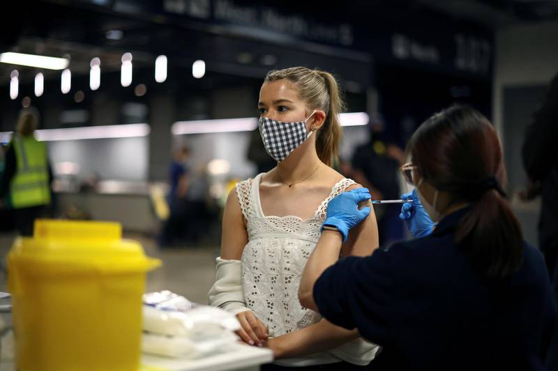 A person receives a dose of the Pfizer/BioNTech vaccine at the Tottenham Hotspur Stadium, in London. Reuters