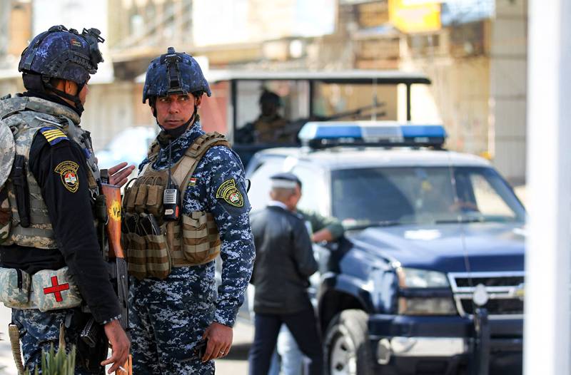 Iraqi federal police forces stand guard at a checkpoint in a street in the capital Baghdad. AFP Photo