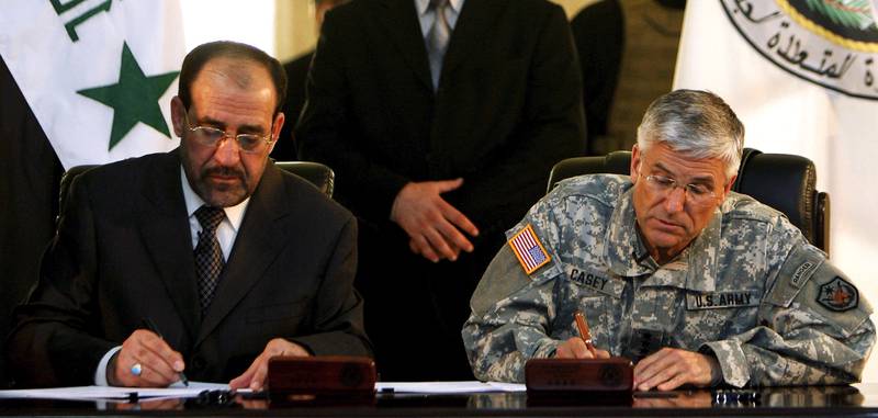 Prime minister Nouri Al Maliki and US Gen George Casey sign an accord in Baghdad, Iraq, on September 7, 2006. The coalition commander signed over operational control of the Iraqi armed forces, air force and navy to the Iraqi government.