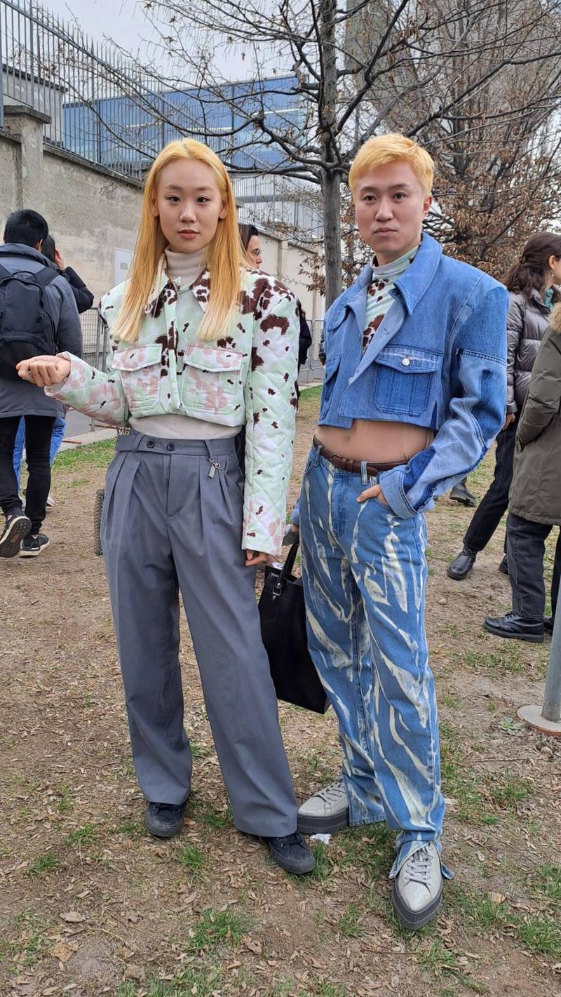 A co-ordinated couple in cropped jean jackets outside the Prada show