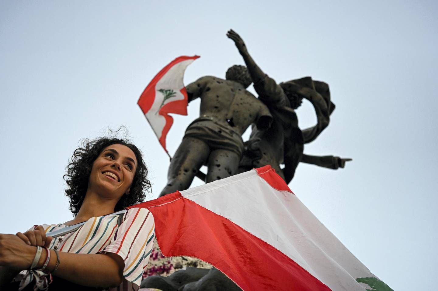 Feyrouz Abou Hassan with her giant Lebanese flag during protests in Beirut in November 2019. Finbar Anderson for The National