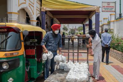 Volunteers load meals to be donated to patients across the city suffering from Covid-19, made at the Gurudwara Bangla Sahib, in New Delhi. Getty Images
