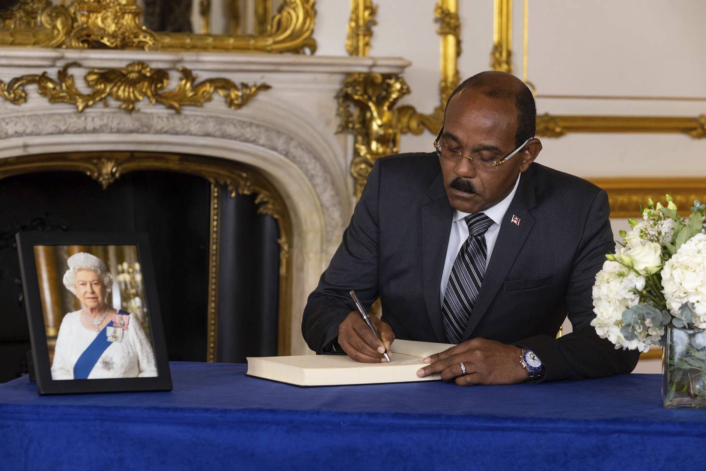 Gaston Browne, Prime Minister of Antigua and Barbuda, signs a book of condolence on the death of Queen Elizabeth at Lancaster House in London. AP