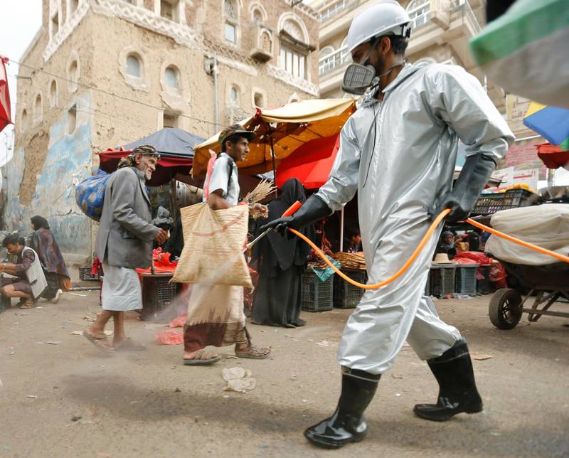 A health worker wearing a protective suit disinfects a market amid concerns of the spread of the coronavirus disease (COVID-19), in Sanaa, Yemen April 28, 2020. REUTERS/Khaled Abdullah