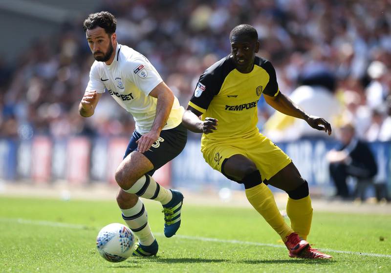 PRESTON, ENGLAND - MAY 06: Greg Cunningham of Preston North End is challenged by Marvin Sordell of Burton Albion during the Sky Bet Championship match between Preston North End and Burton Albion at Deepdale on May 6, 2018 in Preston, England.  (Photo by Nathan Stirk/Getty Images)