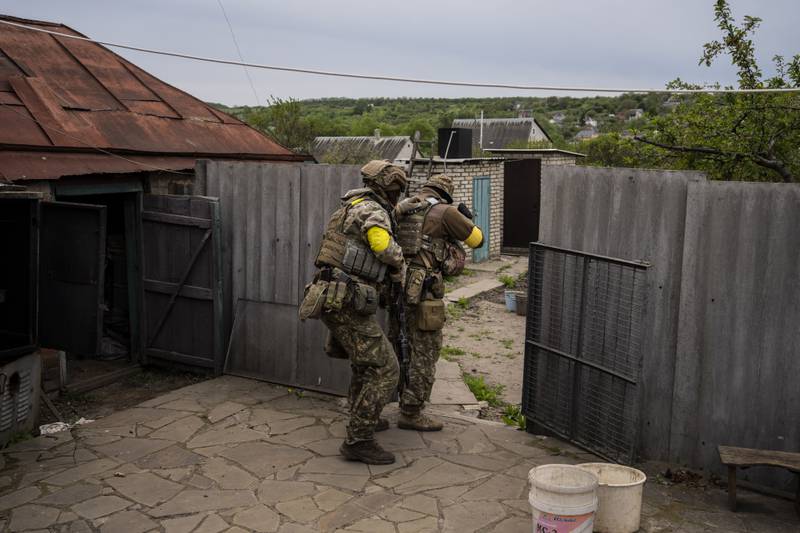 Ukranian troops take positions in a village recaptured from Russian forces near Kharkiv, Ukraine. AP