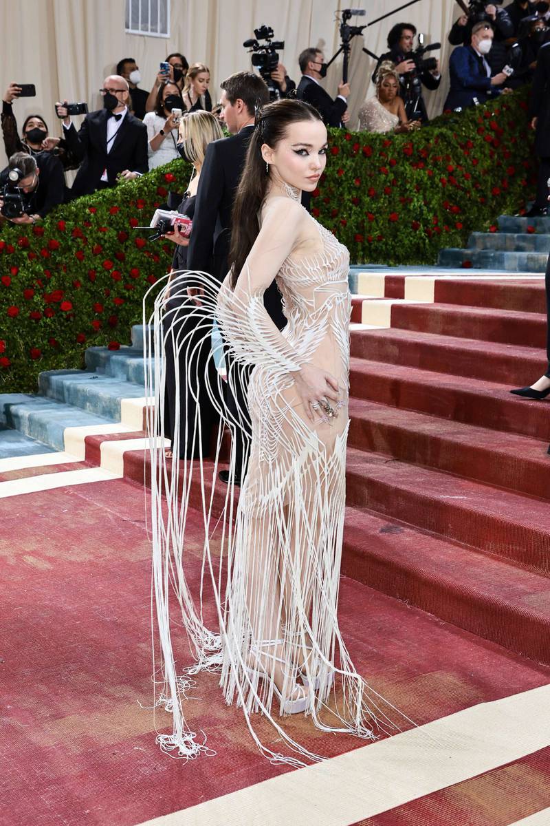 Dove Cameron, in a sheer gown with wing detail. AFP