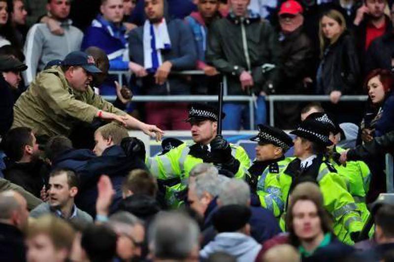 Millwall fans clash with police during the FA Cup semi-final match against Wigan Athletic at Wembley Stadium. Glyn Kirk / AFP