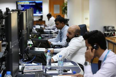 Traders at the National Bank of Fujairah office in Dubai. Longer hours don't necessarily lead to greater productivity. (Pawan Singh / The National)