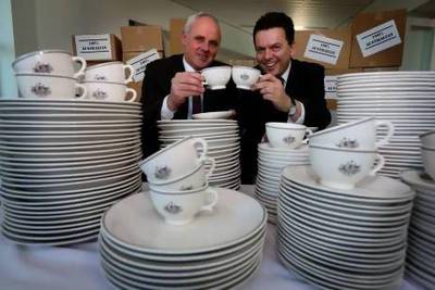 Senators John Madigan and Nick Xenophon with the plates, cups, bowls and saucers they had made especially for Parliament House in Canberra to replace those made in the UAE. Courtesy heraldsun.com.au