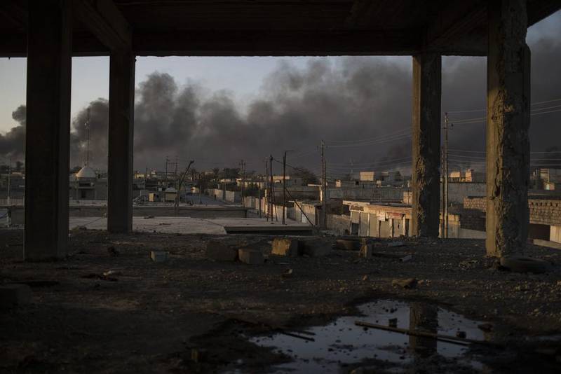 Smoke rises from burning oil fields in Qayara, 50 kilometres south of Mosul. Felipe Dana / AP Photo