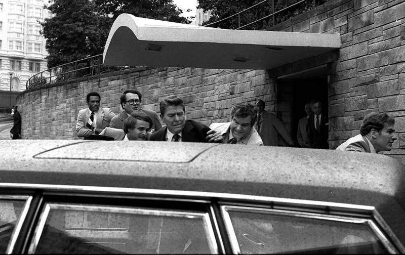 Ronald Reagan, the US president at the time, is shoved into his limousine by secret service agents after being shot outside a Washington hotel on March 30, 1981. AP