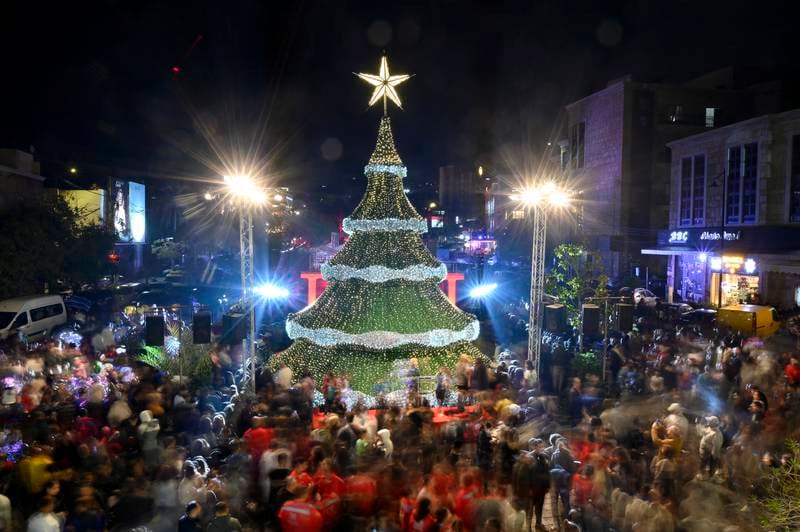 Crowds gather around a giant Christmas tree that has been officially lit up at the entrance of Byblos, in Lebanon, on Thursday. EPA