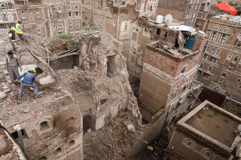 Workers demolish a building damaged by rain in the UNESCO World Heritage site of the old city of Sanaa, Yemen. REUTERS
