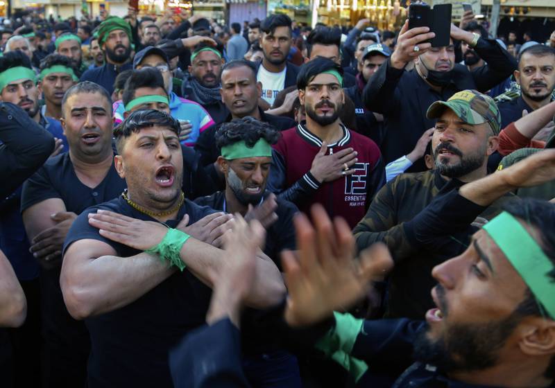 Shiite pilgrims beat themselves as a sign of grief outside the golden-domed shrine of Imam Moussa Al Kadhim. AP
