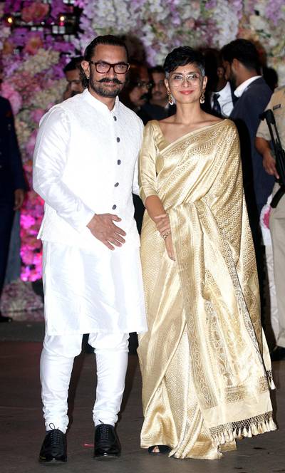 Aamir Khan poses for a picture with his wife Kiran Rao Khan as they attend the engagement party of India's richest man and Reliance Industries Limited Chairman, Mukesh Ambani’s eldest son Akash Ambani and fiancee Shloka Mehta, in Mumbai on June 30, 2018. AFP