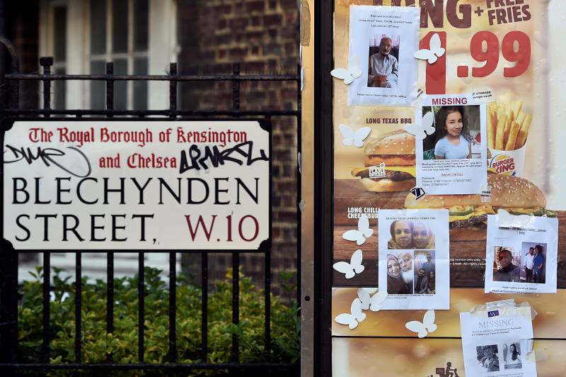 Missing persons posters were displayed in a street near the scene in the aftermath of the fire. Reuters