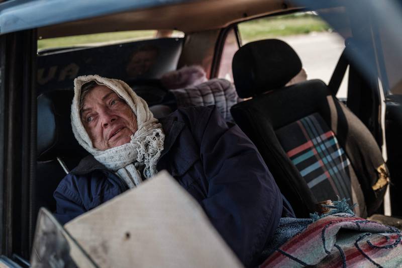Galina Abdurashikova, 65, has been staying in an abondoned car in front of her apartment since her room was destroyed by shelling five days ago, in Severodonetsk. AFP